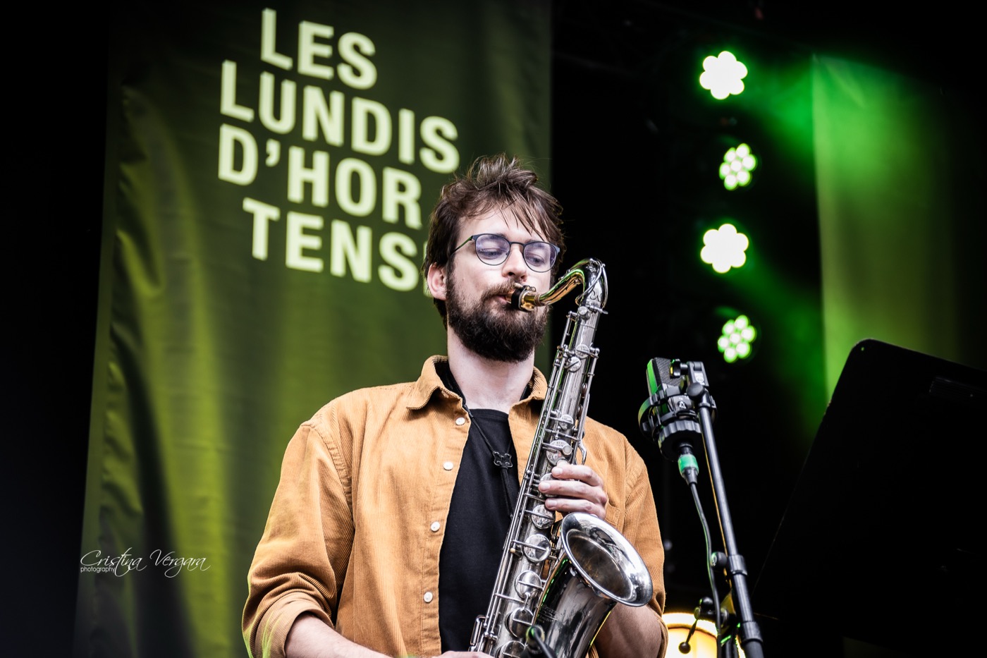 Warre playing tenor saxophone on a festival stage
